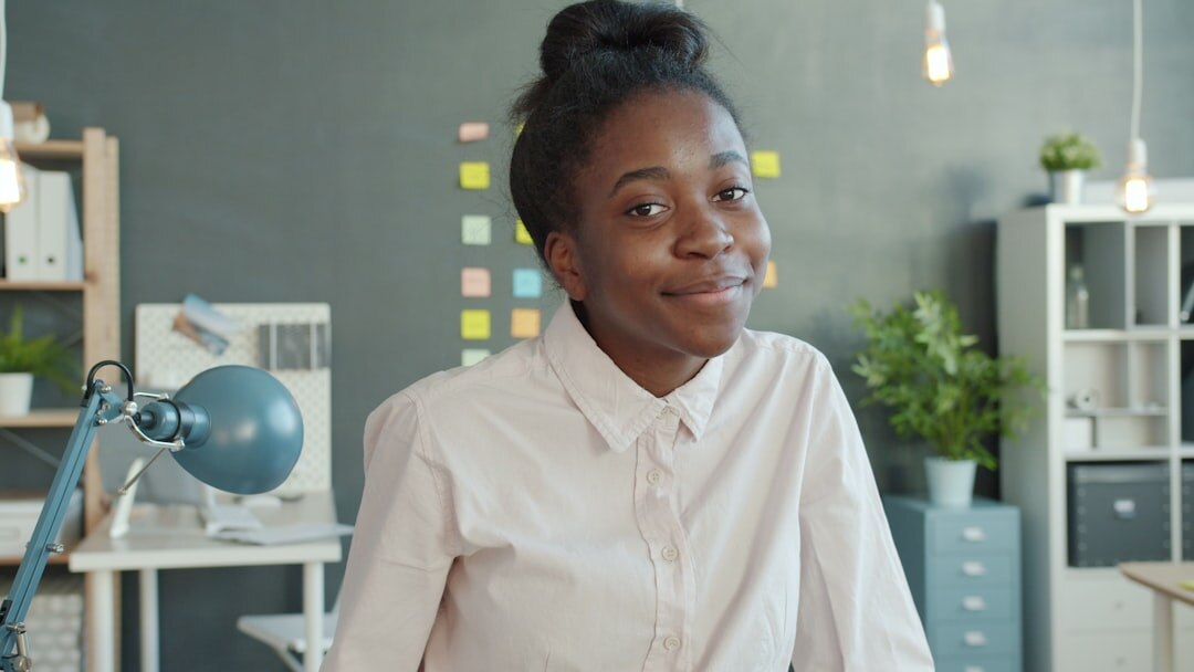 person smiling at desk