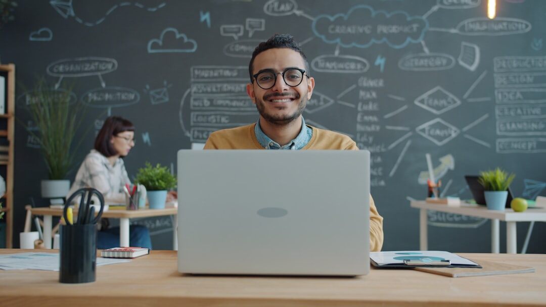 person smiling at desk